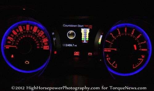 The gauge cluster of the 2013 Ford Mustang GT Premium Coupe in the dark