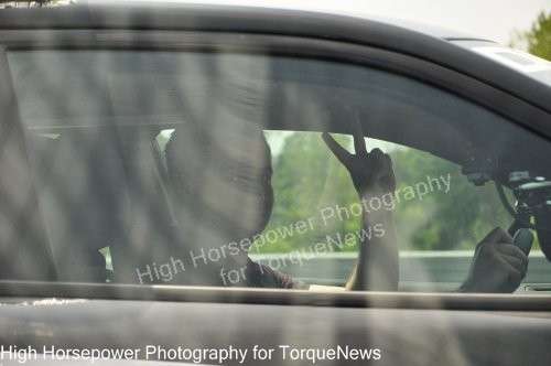 Adam Ferrara giving the peace sign in the Dodge Charger Pursuit