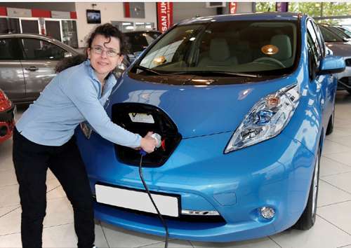 Sylvie Lailler with the 10,000th Nissan LEAF sold in Europe. Courtesy Newspress