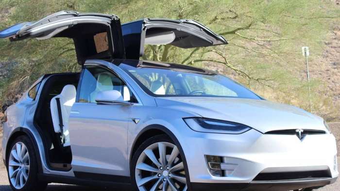 2020 white color Tesla Model X EV SUV with opened Falcon Doors