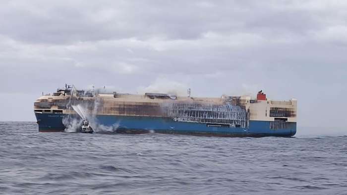 Image showing a firefighter boat attempting to put out the fires aboard the fire-ravaged Felicity Ace car carrier ship.