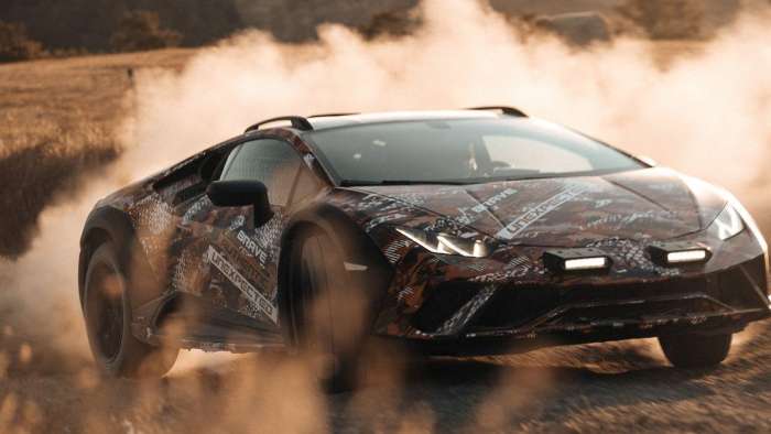 Image showing a Lamborghini Huracan Sterrato kicking up a huge cloud of dust while sliding sideways on a gravel road.