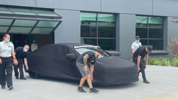 Image showing the Lucid Air Sapphire under a cover as it heads to The Quail for its reveal