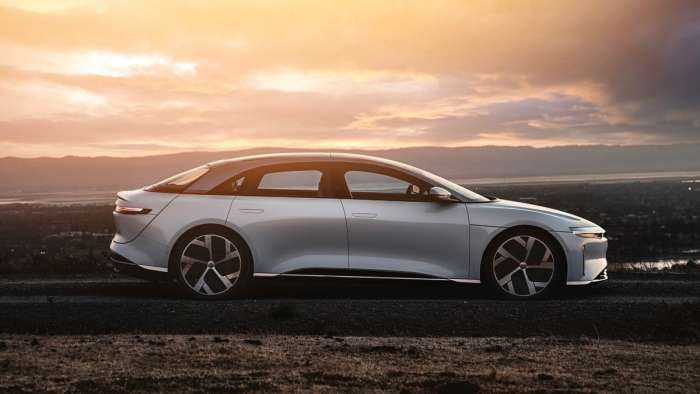 Side profile image of a white Lucid Air at sunset