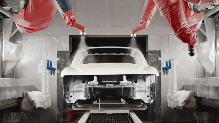 Image showing a Lucid Air receiving a base coat as it passes through the AMP-1 factory's paint booth.