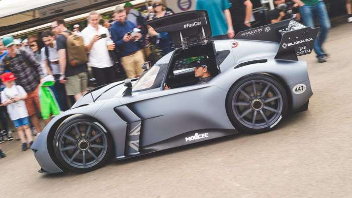 Image of the McMurtry Speirling fan car in the paddock at Goodwood with its gullwing door open.