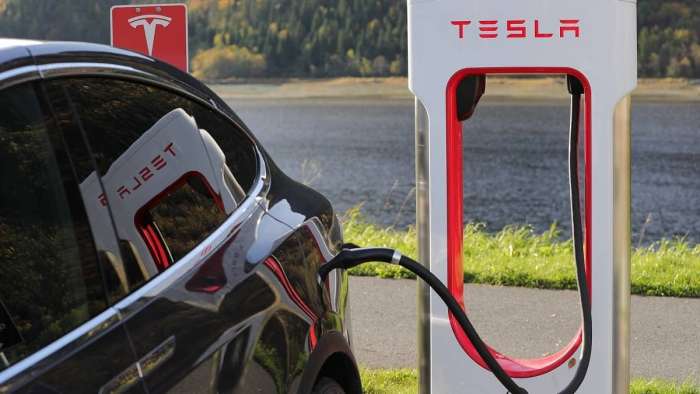 Tesla bearish outlook spreads the markets as Black Tesla Model S is charging at a supercharger