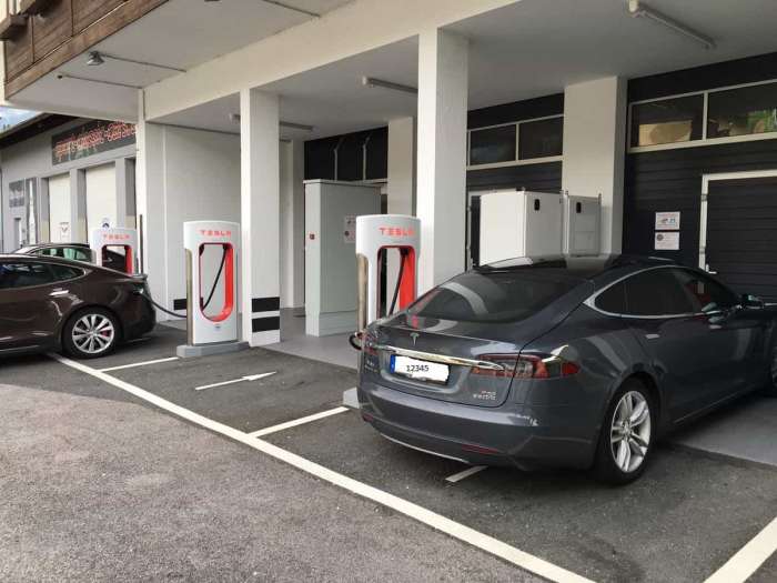 Tesla Model S cars charging at a supercharger