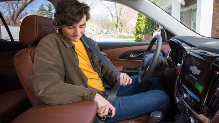 Teen driving a Chevy car