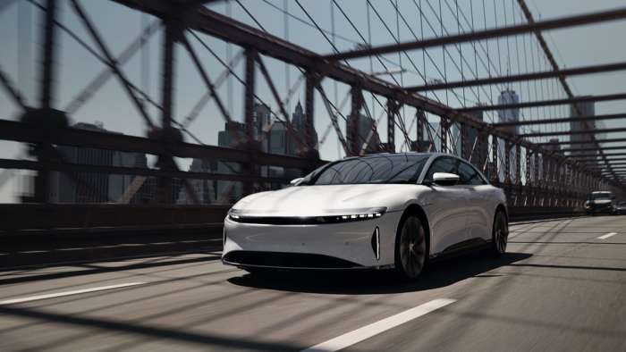 Image showing a white Lucid Air driving across a bridge.