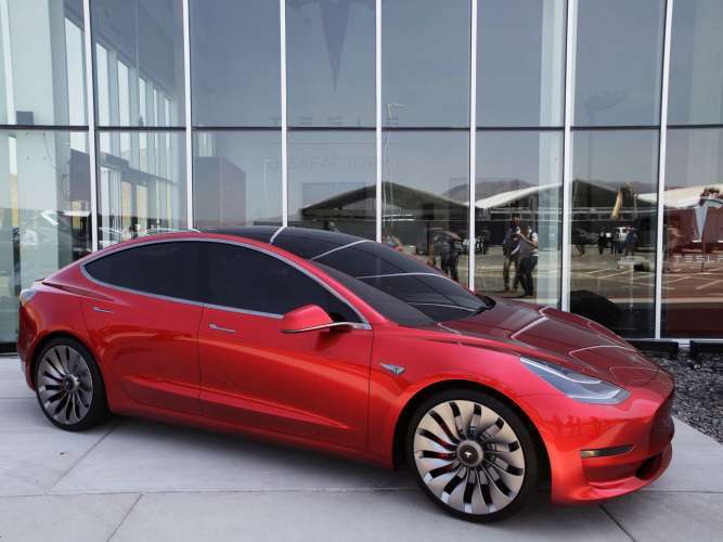 Red color Tesla Model 3 with great wheels