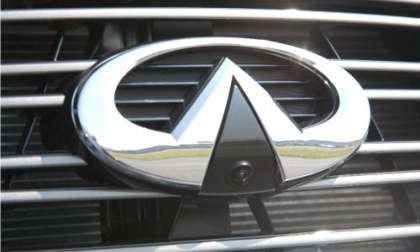 This image of an Infiniti logo shows the camera/sensor at the bottom of the oval