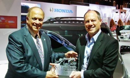 MotorWeek's John Davis (left) presents American Honda's VP of marketing operatio