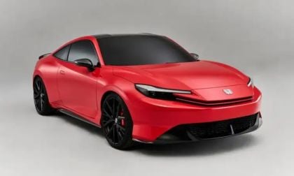 A sporty, red 2026 Honda Prelude concept car with a black roof and black wheels, shown from the front three-quarter angle in a studio setting.