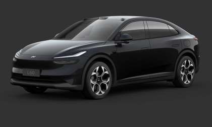 A sleek, black Onvo L60 electric SUV shown in a studio setting against a dark grey background.