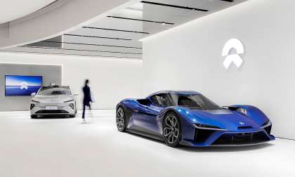 Modern NIO showroom featuring two sleek cars.