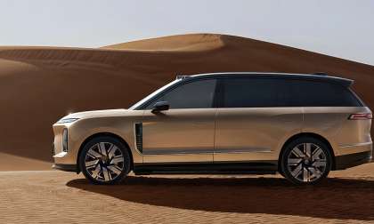 Elegant NIO ES9 SUV parked in sand.