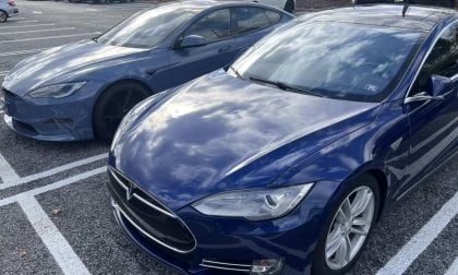 Three Tesla Model S sedans in deep blue metallic, parked side-by-side in a parking lot, showing front quarter views with distinctive LED headlights and chrome trim.