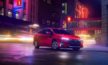 2020 Prius Prime night shot in the city red color front side 