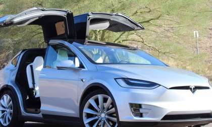 2020 white color Tesla Model X EV SUV with opened Falcon Doors
