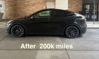 2022 Tesla Model Y, black, side view, featuring distinctive wheels and a clean exterior after 200,000 miles.