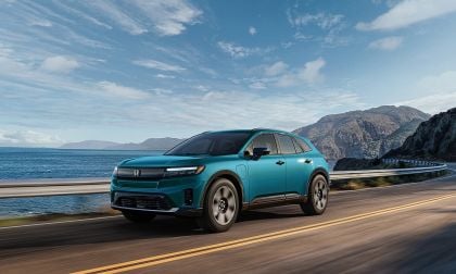 2024 Honda Prologue Elite electric SUV driving along a coastal highway
