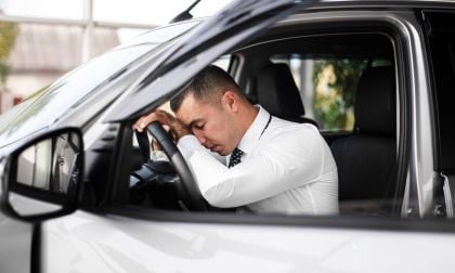 A driver sits in his car 