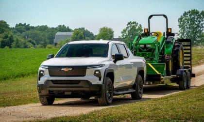 The Chevy Silverado EV effortlessly tows a 10,000-pound John Deere tractor, showcasing its impressive towing capabilities.