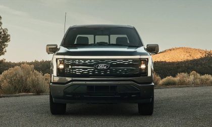 Dark Gray 2025 Ford F-150 Lightning electric truck, front-facing view with rugged mountain landscape background