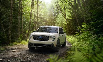 2025 Ford Maverick compact pickup driving on a forest trail, front three-quarter view