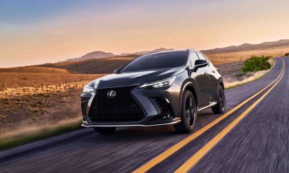 A sleek black Lexus NX driving on a winding road through a desert landscape at sunset, showcasing its stylish design and performance.