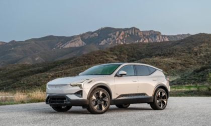 Pearl white Polestar 3 electric SUV parked on mountain road with rugged rocky landscape backdrop