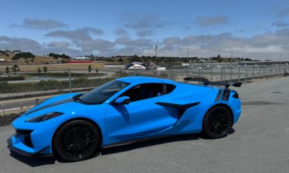 Blue 2025 Chevrolet Corvette C8 shown from front three-quarter angle on a racetrack.