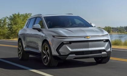 2025 Chevrolet Equinox EV in gray shown at front three-quarter angle, highlighting modern electric SUV design with sleek lines.