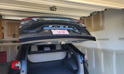 2026 Subaru Solterra inside a garage and the trunk opened hitting the uper part of the garage door