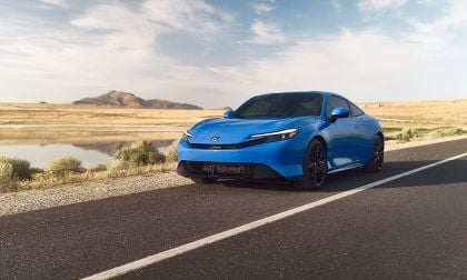 2026 Honda Prelude hybrid coupe in Boost Blue parked on desert road with mountains and reflective lake in background