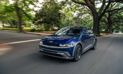 Blue 2026 Hyundai Ioniq 5 driving on a road with motion blur.