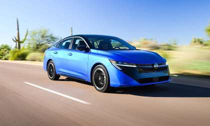Blue 2026 Nissan Sentra SR driving on a sunny desert road.