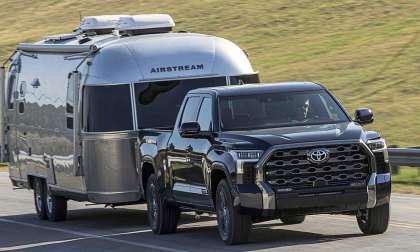 2026 Toyota Tundra confidently towing a trailer in a rural area.