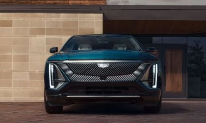 2026 Cadillac Lyriq in green, front view showcasing distinctive grille and LED headlights.