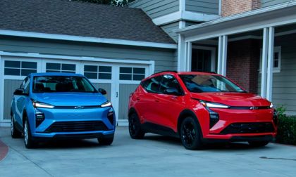 2027 Chevrolet Bolt EV, two of them, blue and red, parked in front of house