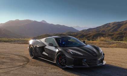 Black 2027 Chevrolet Corvette GSX parked at a mountain overlook, shown from the front three-quarter angle.