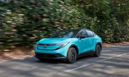 2026 Nissan Leaf in blue shown driving quickly in a forested area