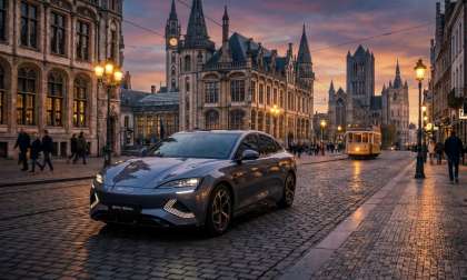 Challenger from the East: A BYD Seal charges past a historic European landmark at dusk, its modern form a stark contrast to the architecture, symbolizing the shifting tides of automotive dominance.