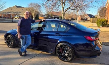 Blue BMW M3 with man standing next to it