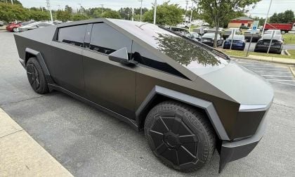 A bronze, 2025 Tesla Cybertruck parked in a lot, showcasing its futuristic design and unique geometric features.
