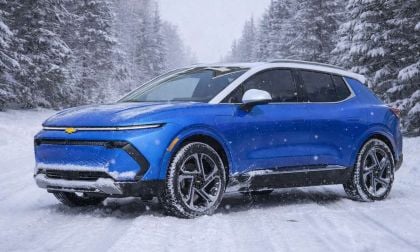 Blue 2025 Chevy Equinox EV on a cold winter road