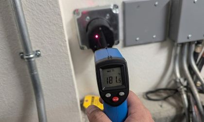 Infrared thermometer measuring 181 degrees on EV charger outlet showing heat buildup