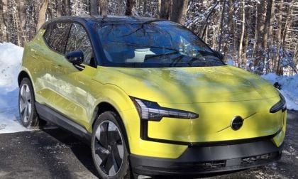 A Volvo EX30 looks sporty in yellow against a winter backdrop