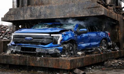 Blue Ford F-150 Lightning in a car crusher